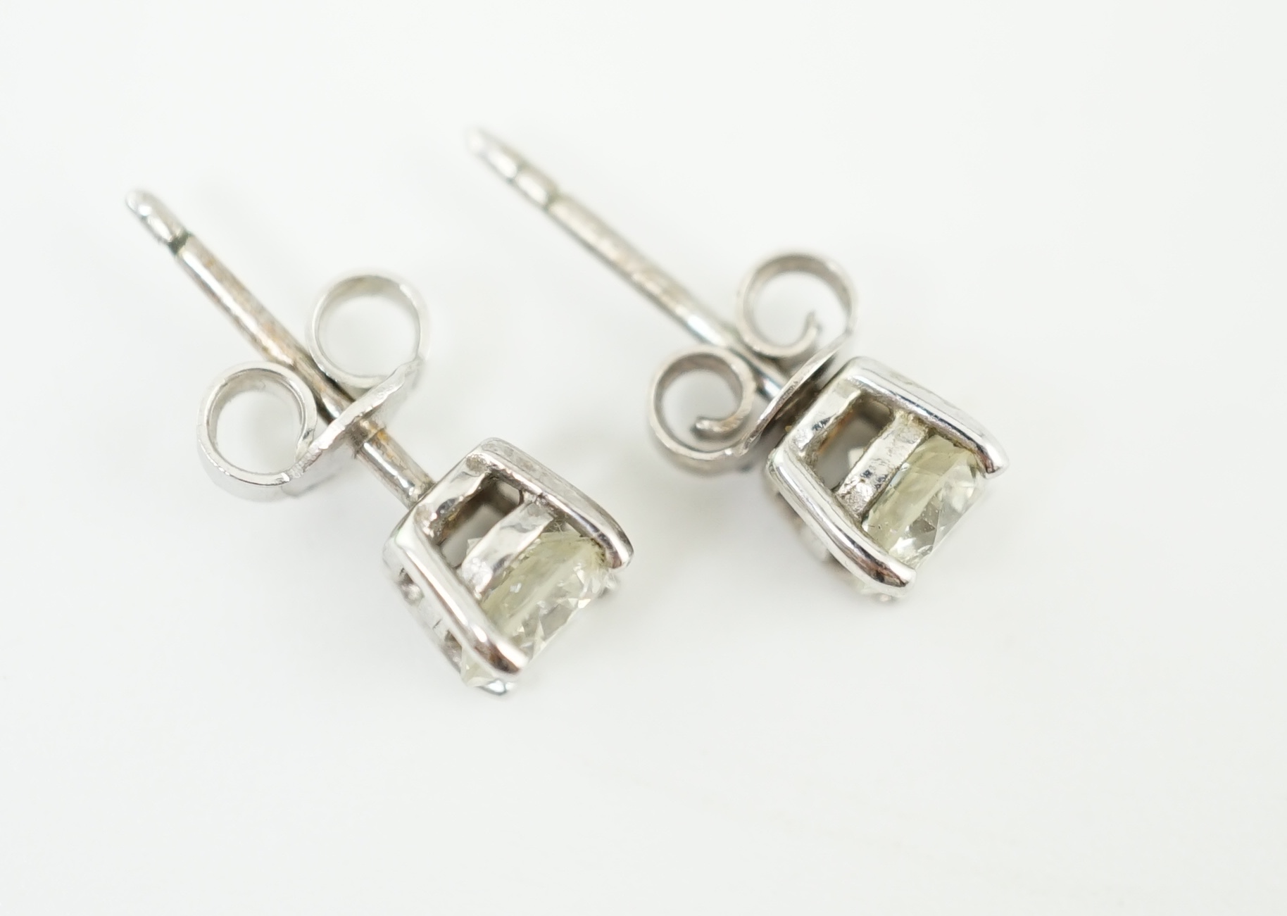 A pair of 18k white gold and solitaire diamond set ear studs